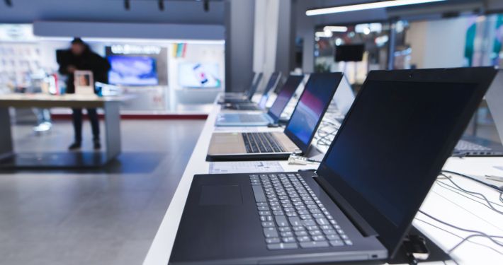 Laptops on the table in the electronics store. The department of laptops in the tech store. Buy a laptop